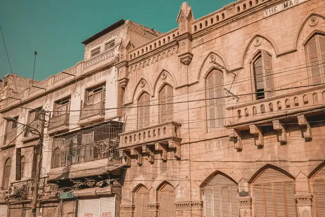 Old stone commercial buildings on a market street in Karachi's old city