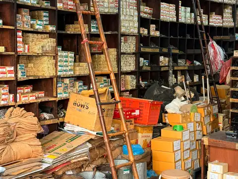 Shelves of boxed hardware stock in a trade shop