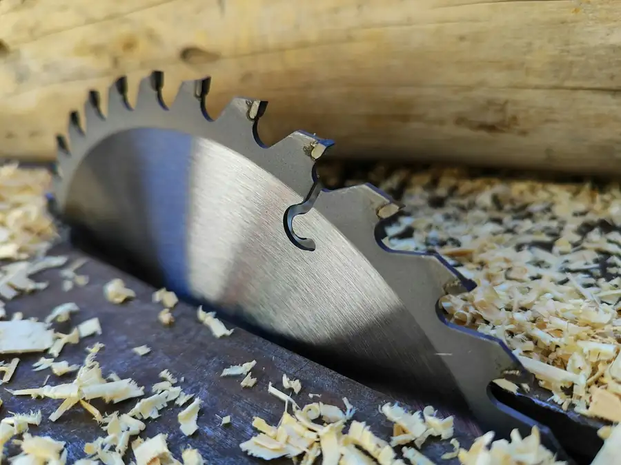 Saw blade cutting into a board