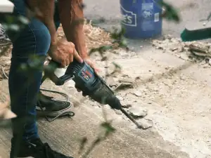 Rotary hammer breaking a concrete floor