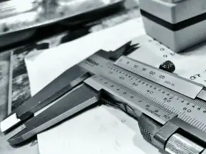 Vernier caliper resting on a steel rule