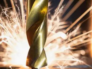 Drill bit cutting metal, sparks flying
