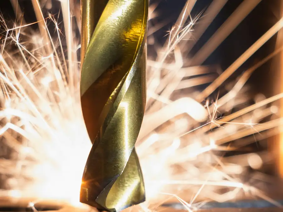 Drill bit cutting metal, sparks flying
