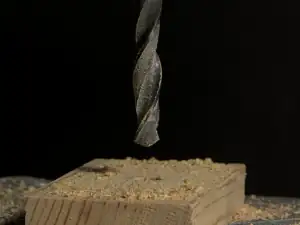 Drill bit above a piece of timber