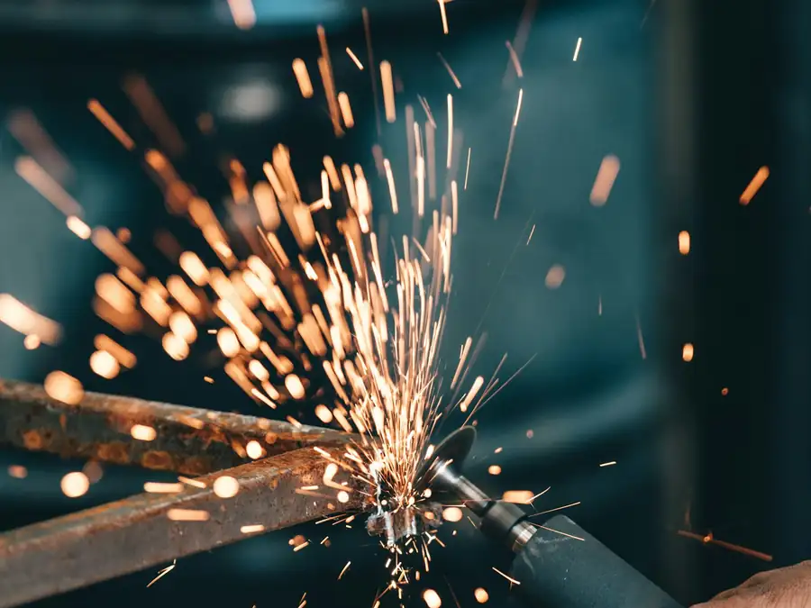 Grinder throwing sparks off a steel edge