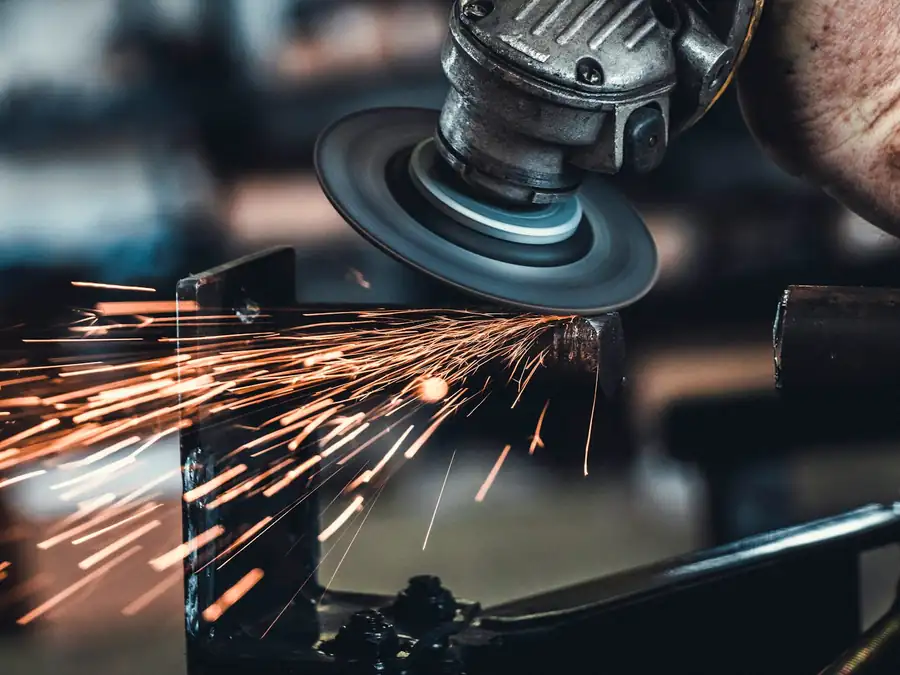 Angle grinder in use on metal