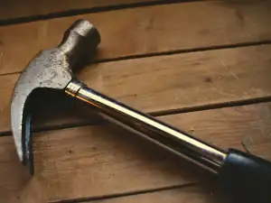 Claw hammer on a wooden bench