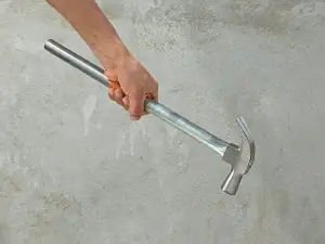 Chiselling into a concrete wall