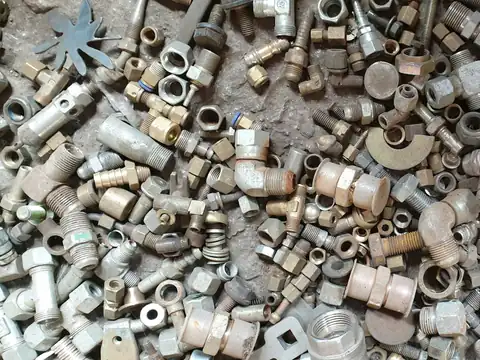 Pile of galvanised pipe fittings: sockets, elbows and unions