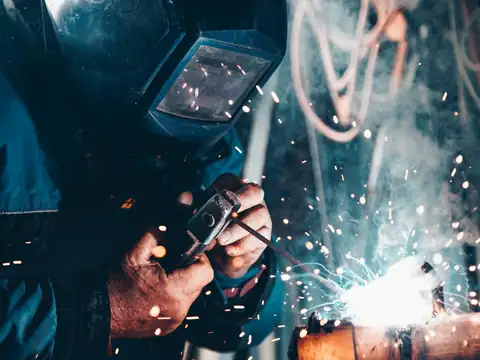 Welder in a shield with sparks flying
